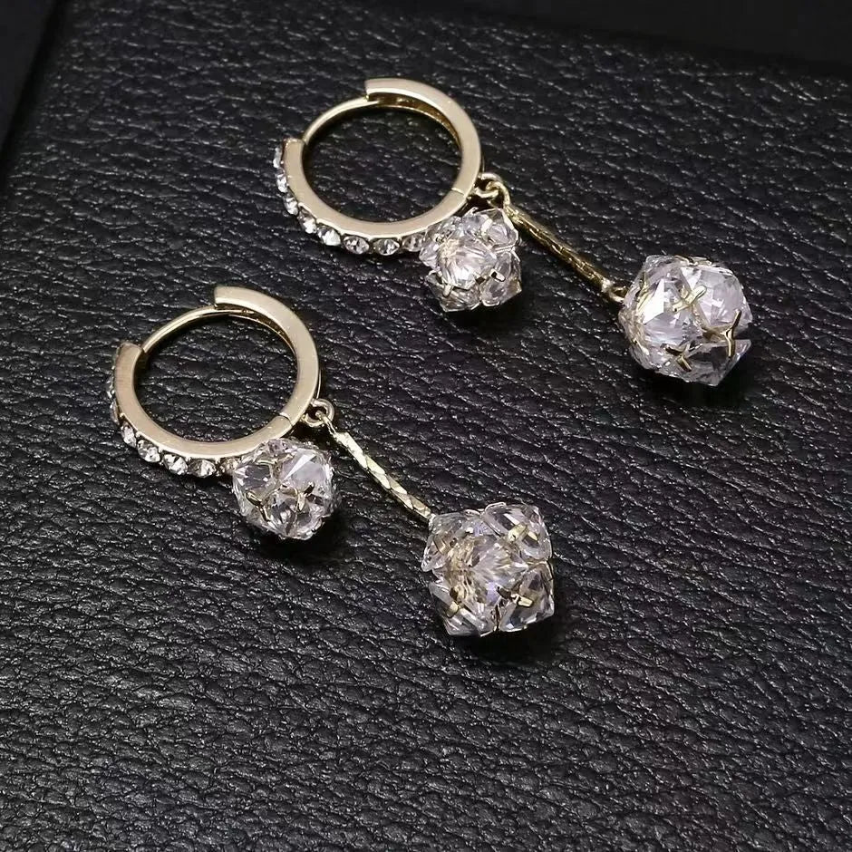 Silver women's clip-on drop earrings with a tassel ball and rhinestone ball pendant.