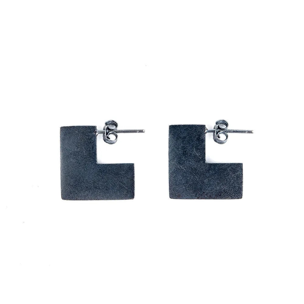 Oxidation black geometric square sterling silver earrings on a white background.