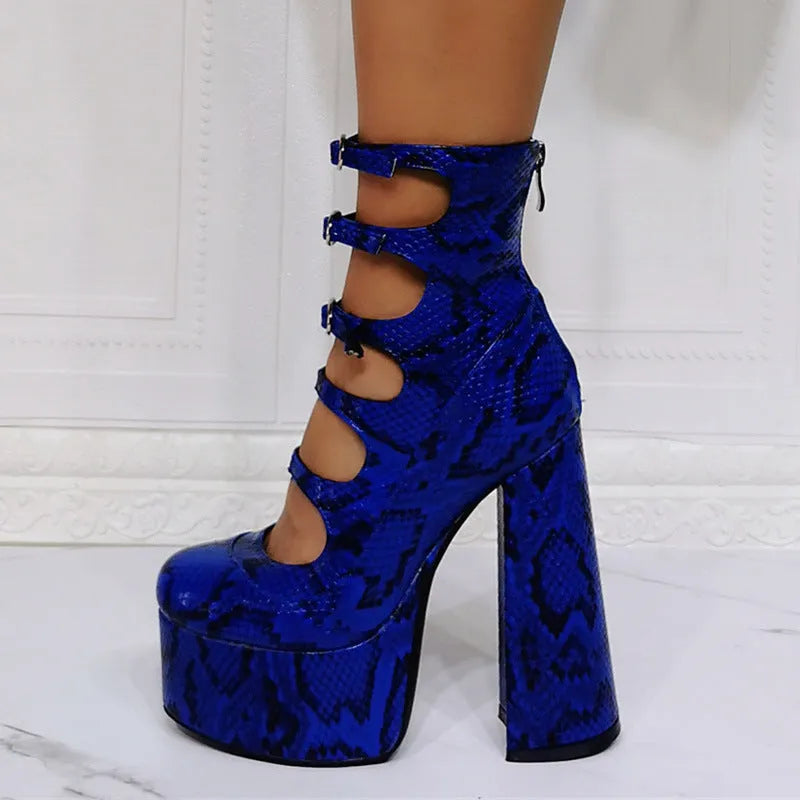 Women's black patent leather platform heel ankle boots with a thick heel and serpentine belt buckle.