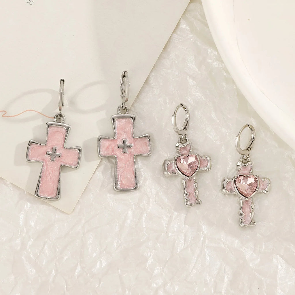 Women's alloy earrings with cross, crystal and character designs in white, black and silver colour variations