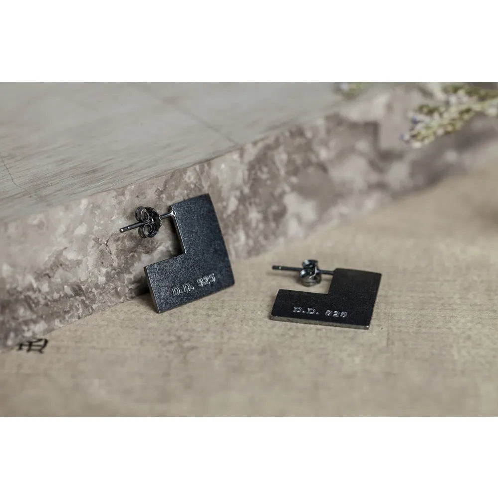 Oxidation black geometric square sterling silver earrings on a white background.