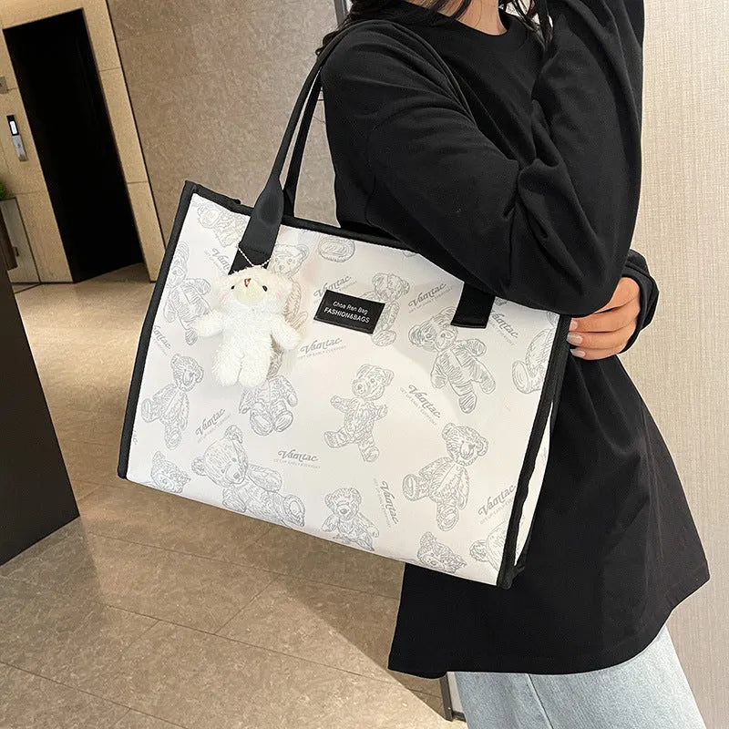 Women's black and white rhombus print canvas tote bag with horizontal square shape and shoulder strap