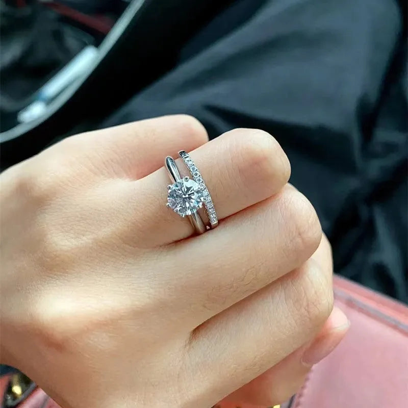 Silver heart-shaped couple rings with dragon phoenix design and adjustable opening showing moissanite stones