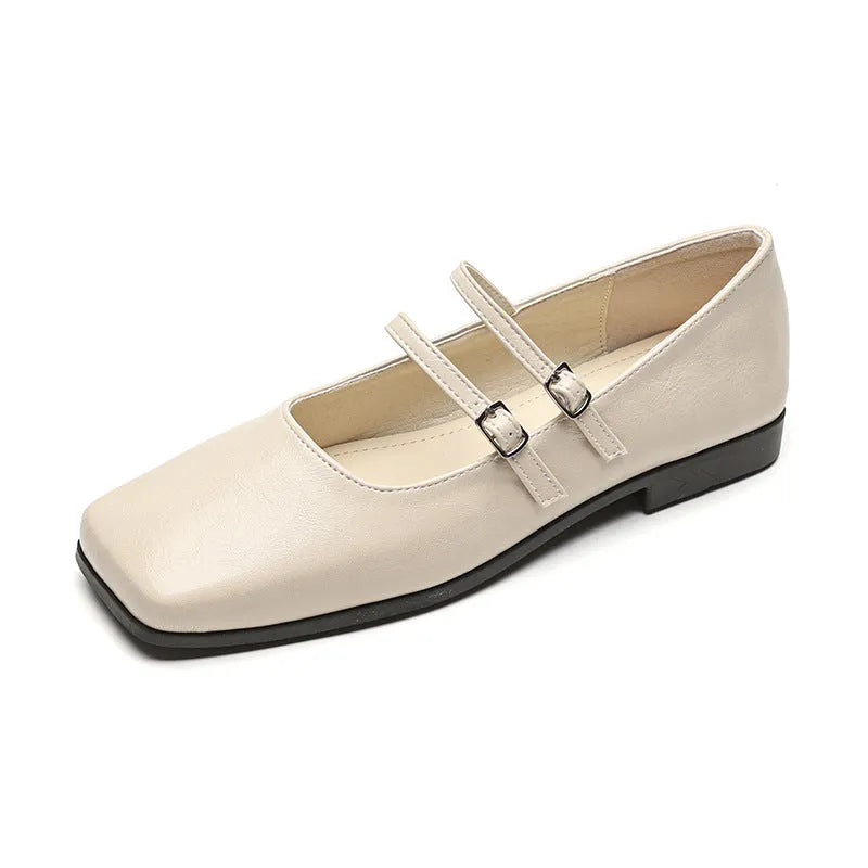 Silver women's leather Mary Jane flats with a cross buckle strap and round toe.