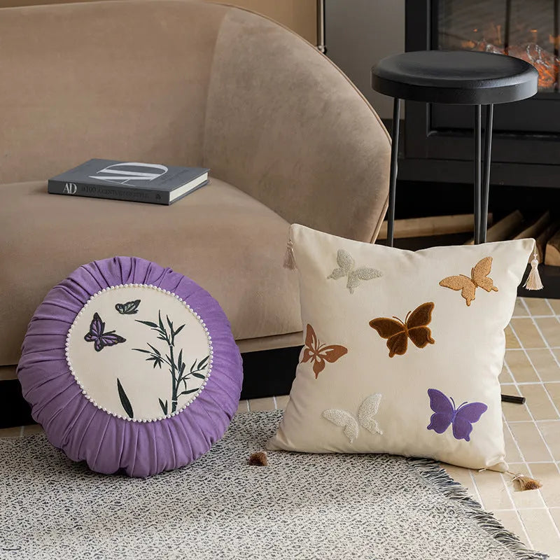 Square beige cushion with detailed black and purple butterfly embroidery in a Chinese style.