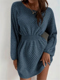 Blue women's knitted dress with hand-crocheted flowers, fitted waist, and loose round neck.