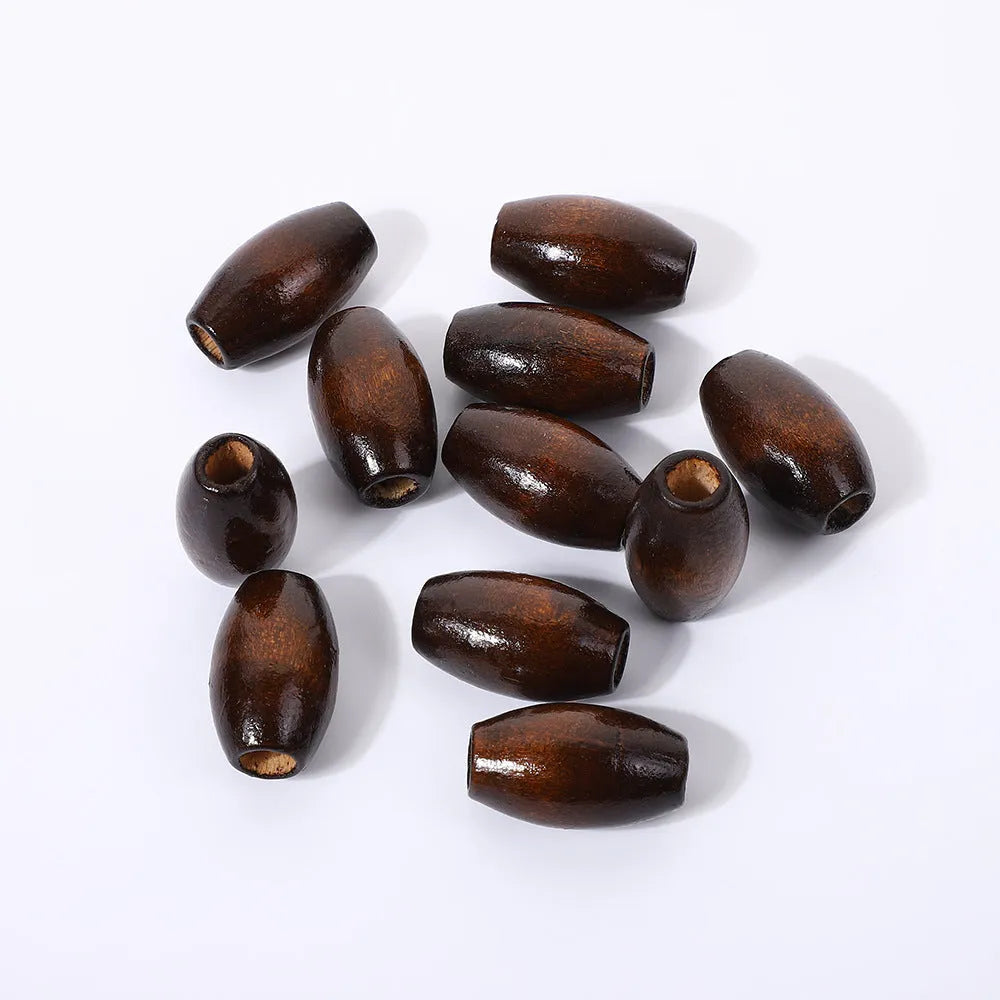 Dark coffee coloured oval wooden bead with raised M-shaped design, showing 6mm centre hole.