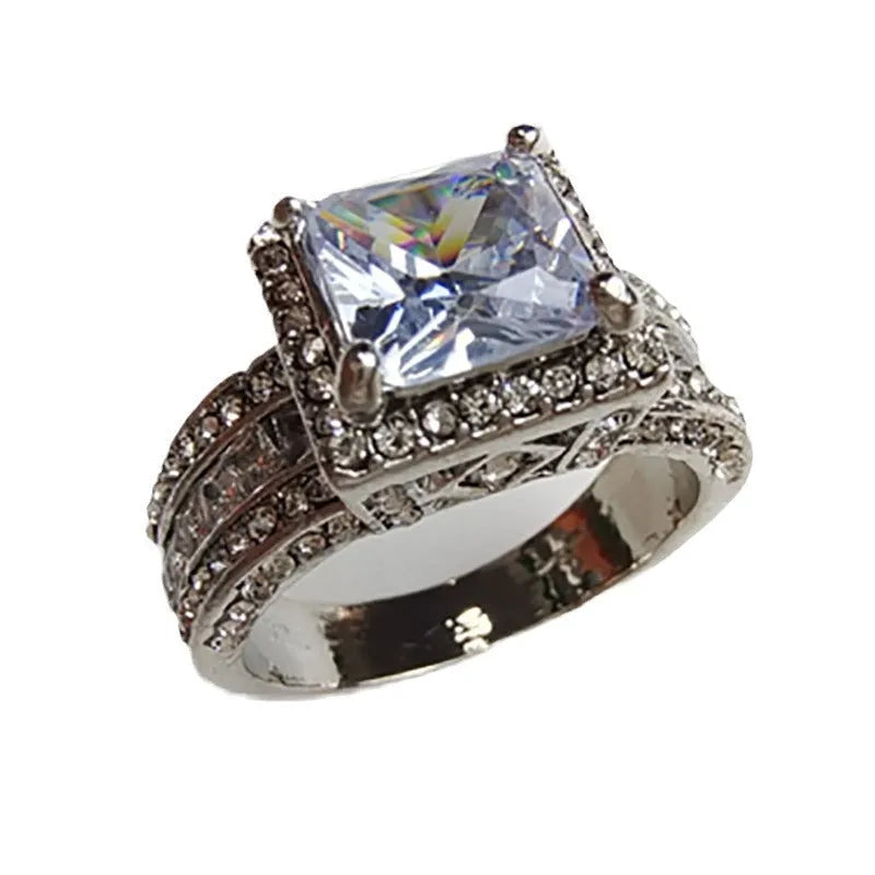 Geometric silver fashion ring for women on a hand, shown in both gold and white colour options.