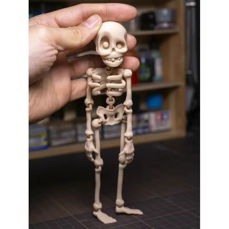 Large white 3D printed skull fridge magnet on a refrigerator door.