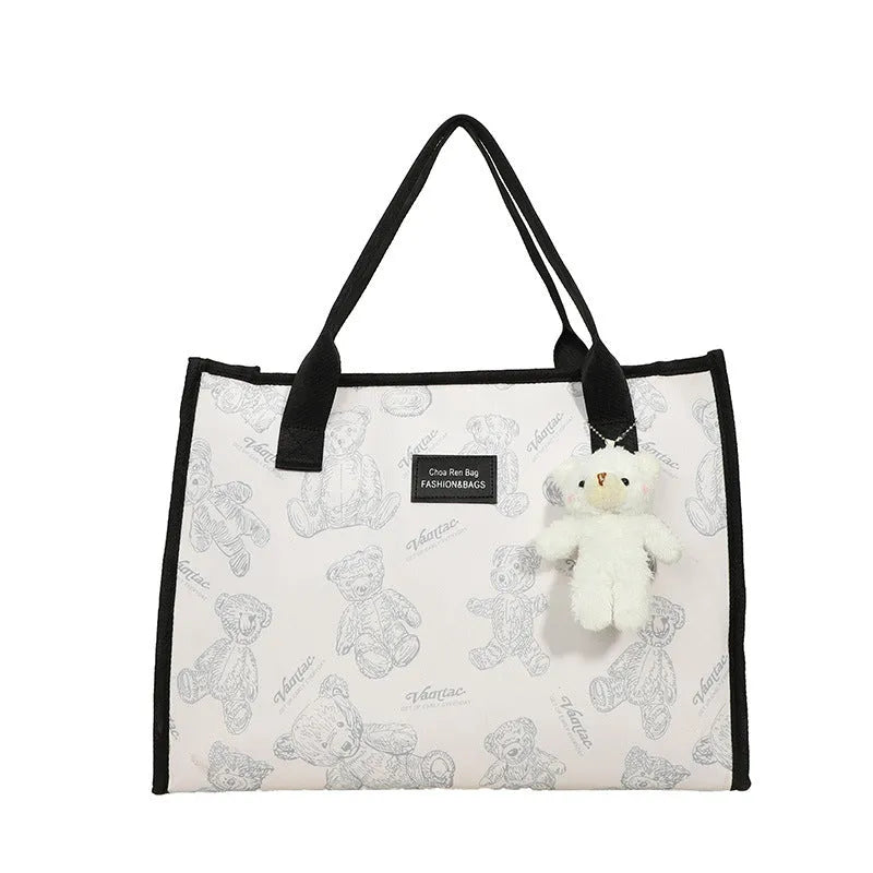 Women's black and white rhombus print canvas tote bag with horizontal square shape and shoulder strap
