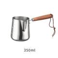 Stainless steel coffee cup with wooden scaled handle showing measurement markings