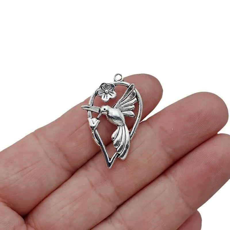 Close-up of an alloy cuckoo magpie pendant with electroplated finish in colour P234 for DIY jewellery.