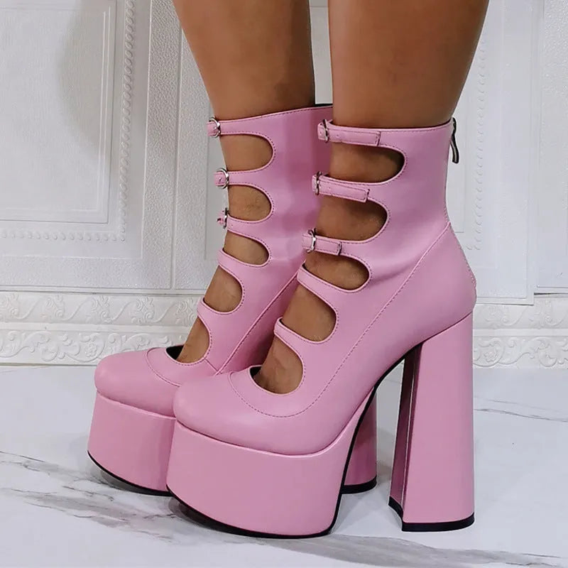 Women's black patent leather platform heel ankle boots with a thick heel and serpentine belt buckle.