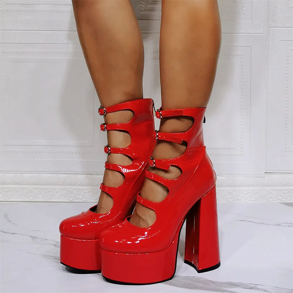 Women's black patent leather platform heel ankle boots with a thick heel and serpentine belt buckle.