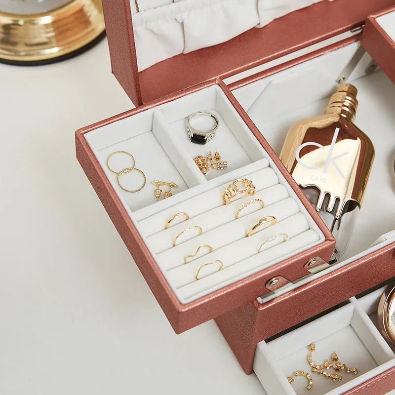 Hard leather jewellery storage box in beige with organiser compartments for rings and necklaces.