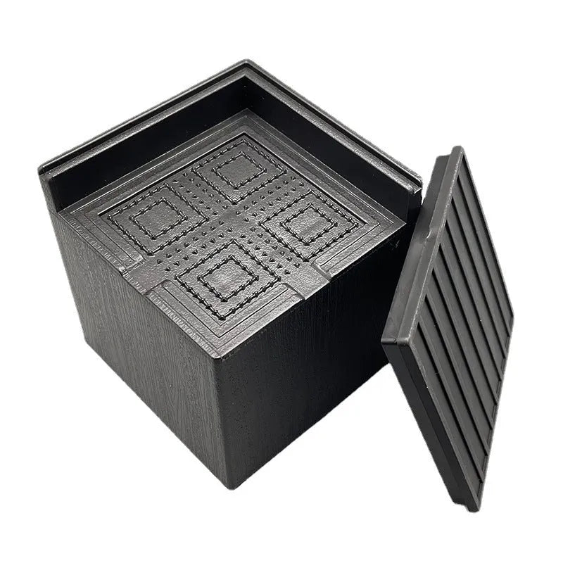Four black plastic bed feet height adjustment mats for furniture levelling
