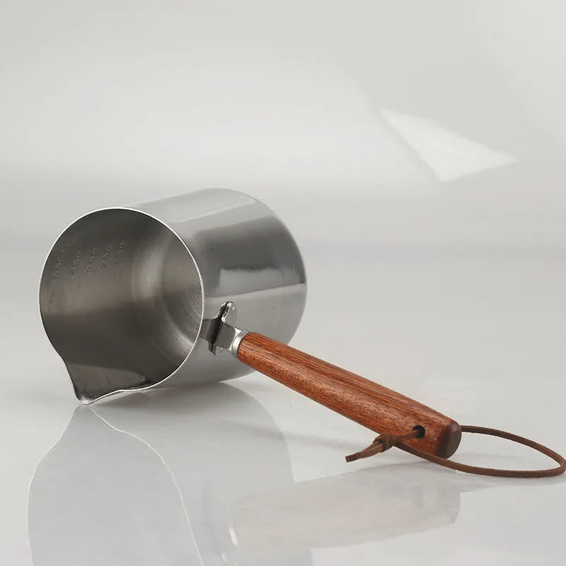 Stainless steel coffee cup with wooden scaled handle showing measurement markings