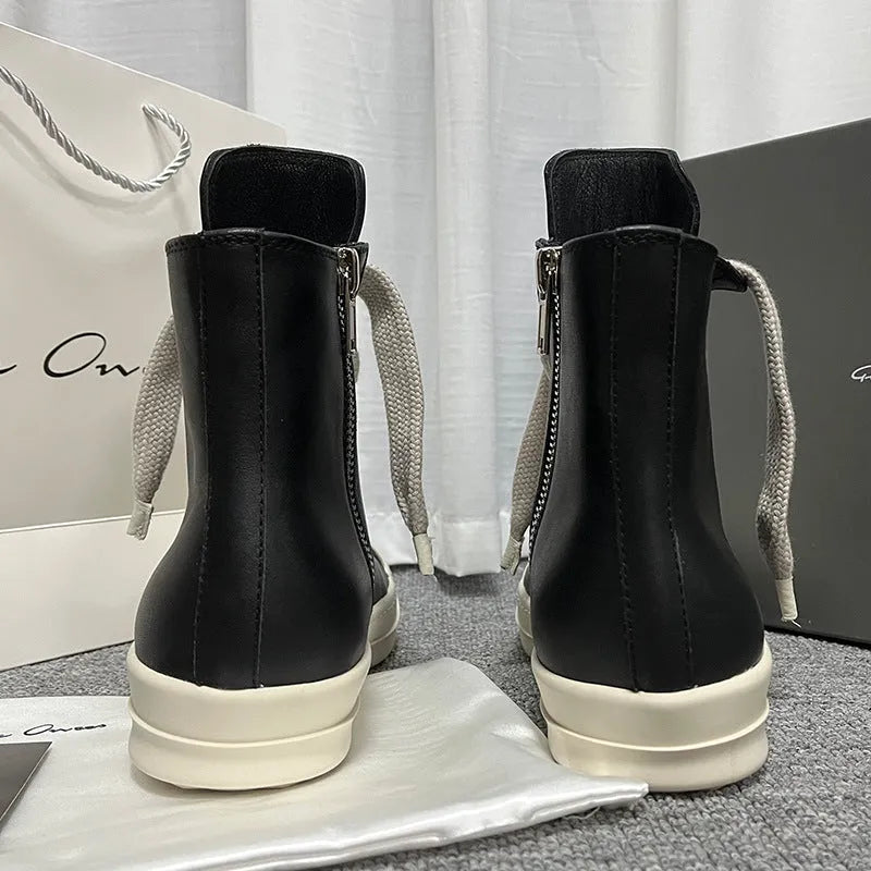 Black high-top leather sneakers with side zipper on a white background