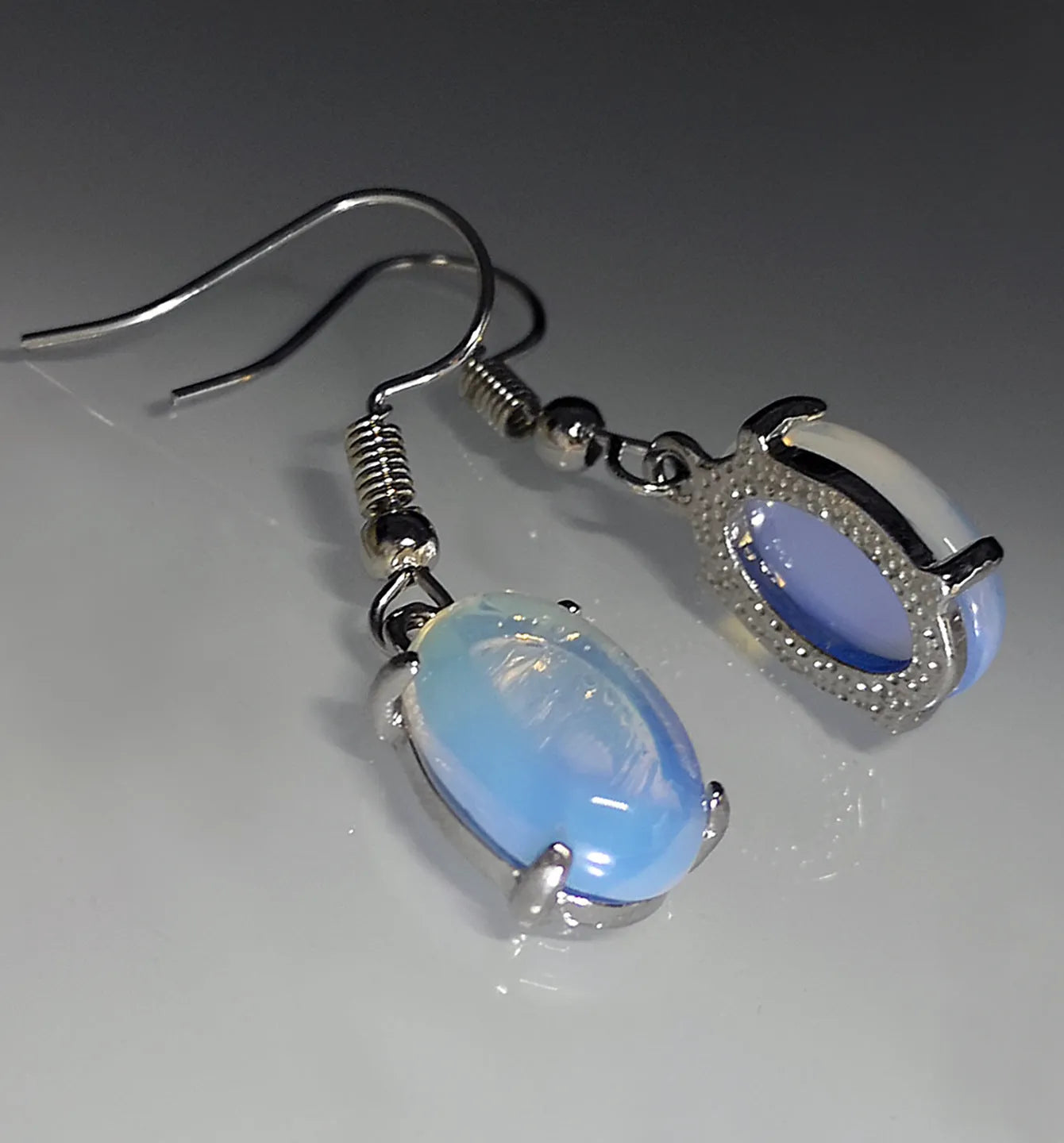 Moonlight white opal earrings with retro drop shape design and ellipse elements