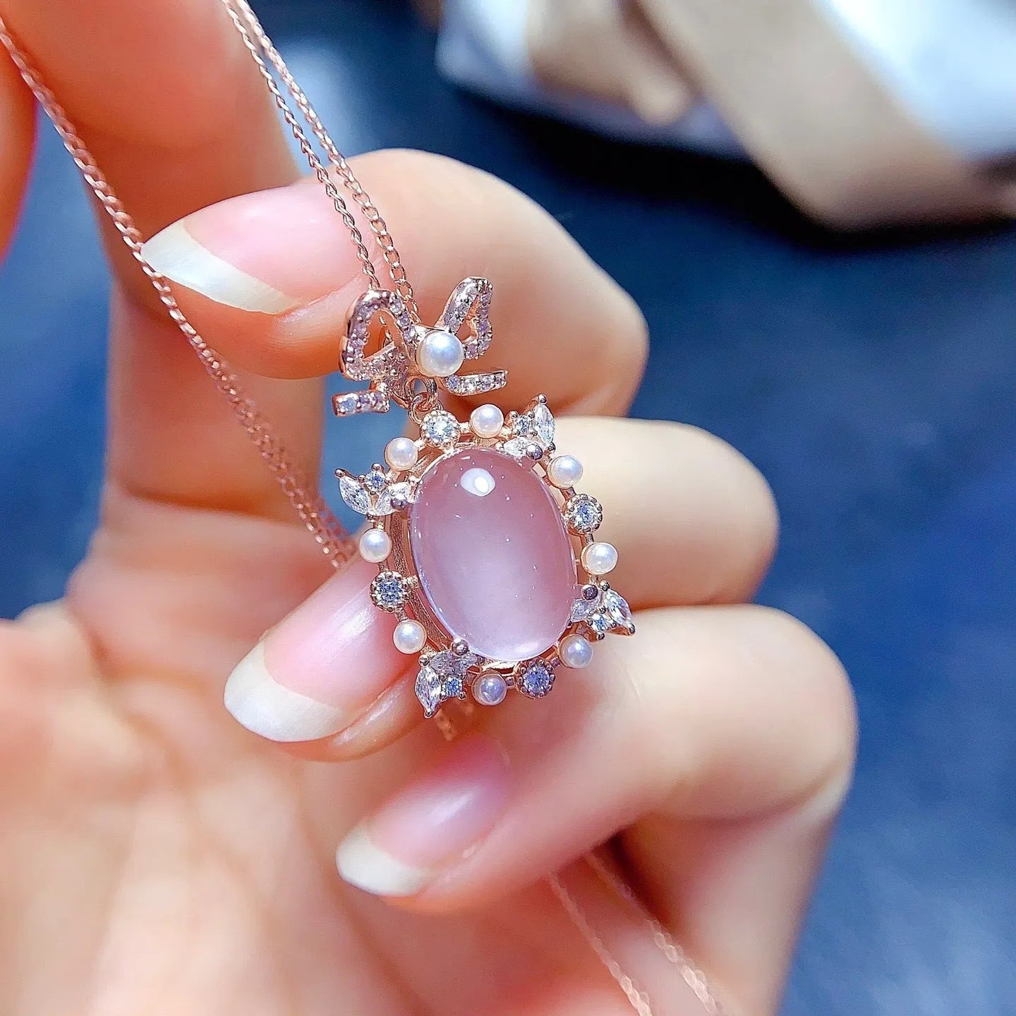 Rose gold plated geometric pendant with pink rose quartz stone on a silver chain.