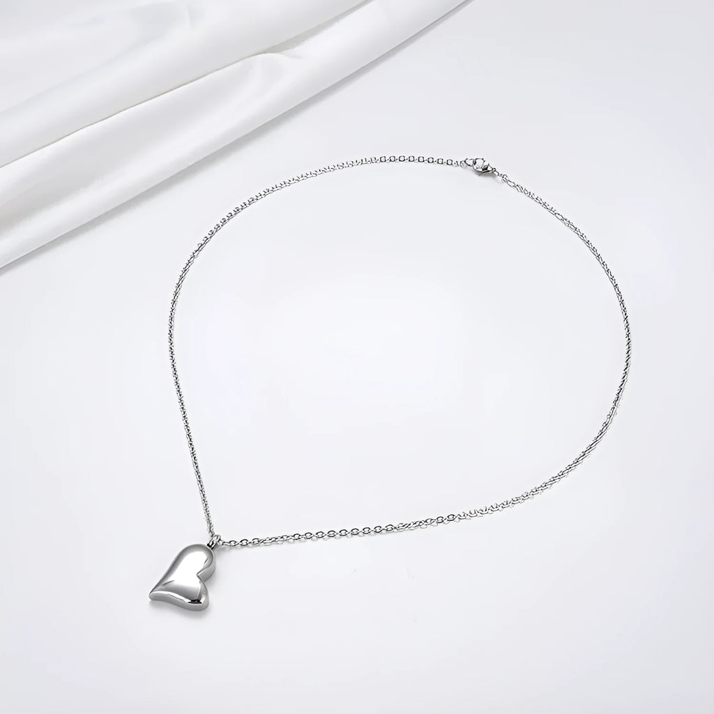 Silver curved peach heart pendant necklace on stainless steel chain with extension