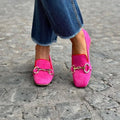Green and rose red suede loafers for women with a metal buckle, flat rubber sole, and round toe.