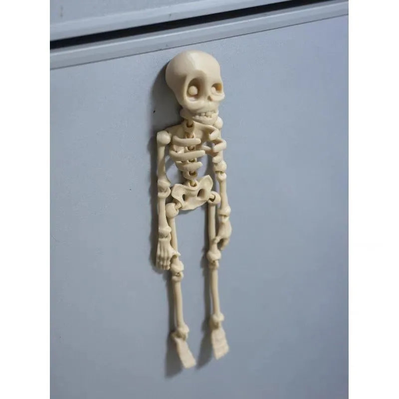 Large white 3D printed skull fridge magnet on a refrigerator door.
