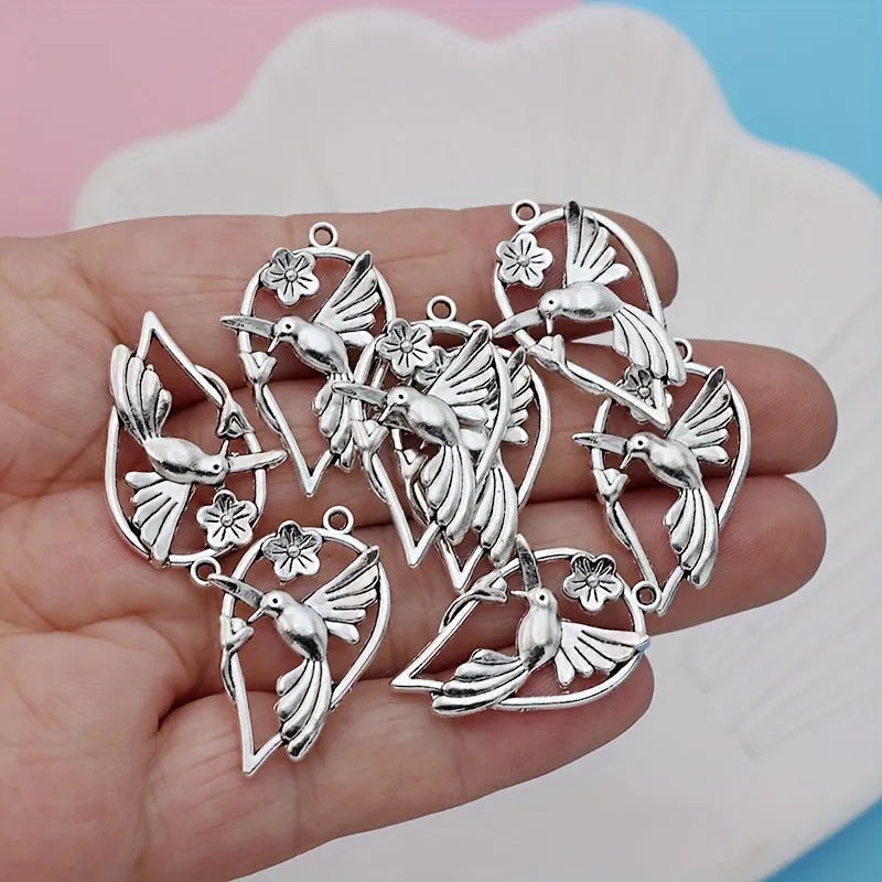 Close-up of an alloy cuckoo magpie pendant with electroplated finish in colour P234 for DIY jewellery.