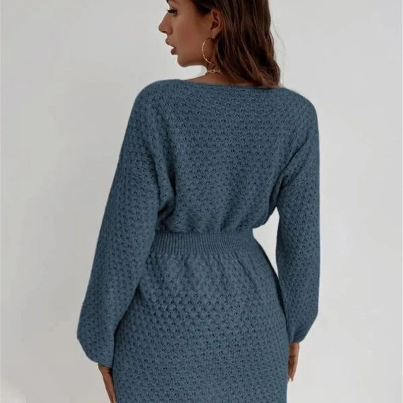 Blue women's knitted dress with hand-crocheted flowers, fitted waist, and loose round neck.