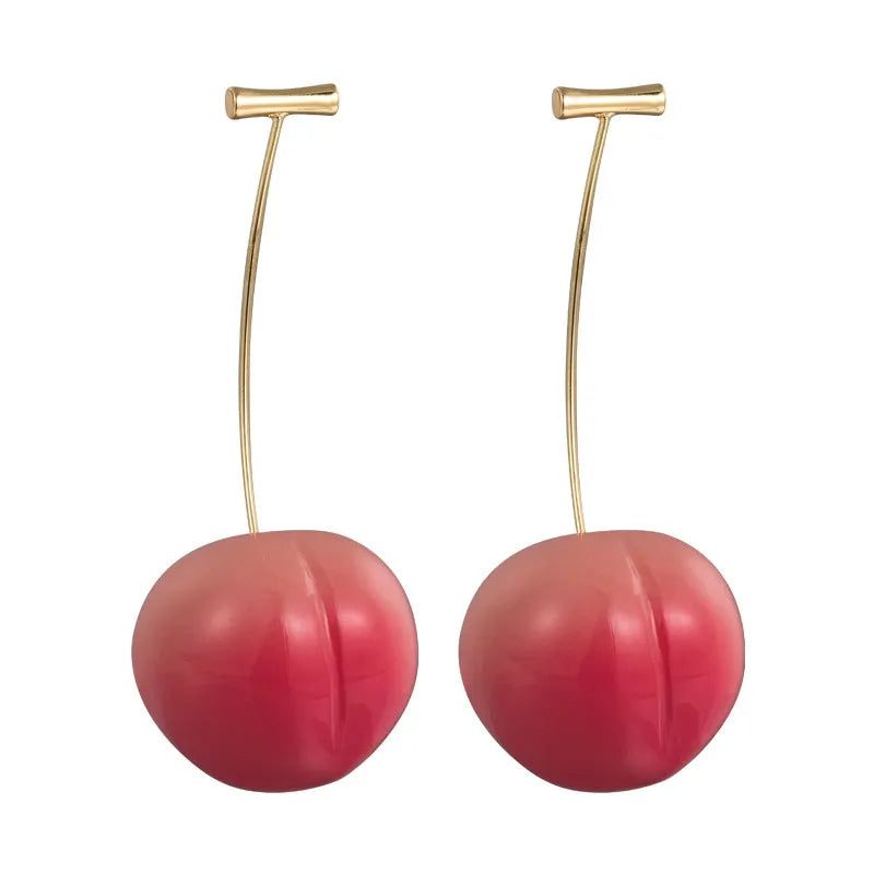 A pair of peach fruit-shaped stud earrings made from red and green acrylic with copper posts.