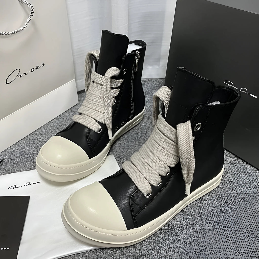 Black high-top leather sneakers with side zipper on a white background