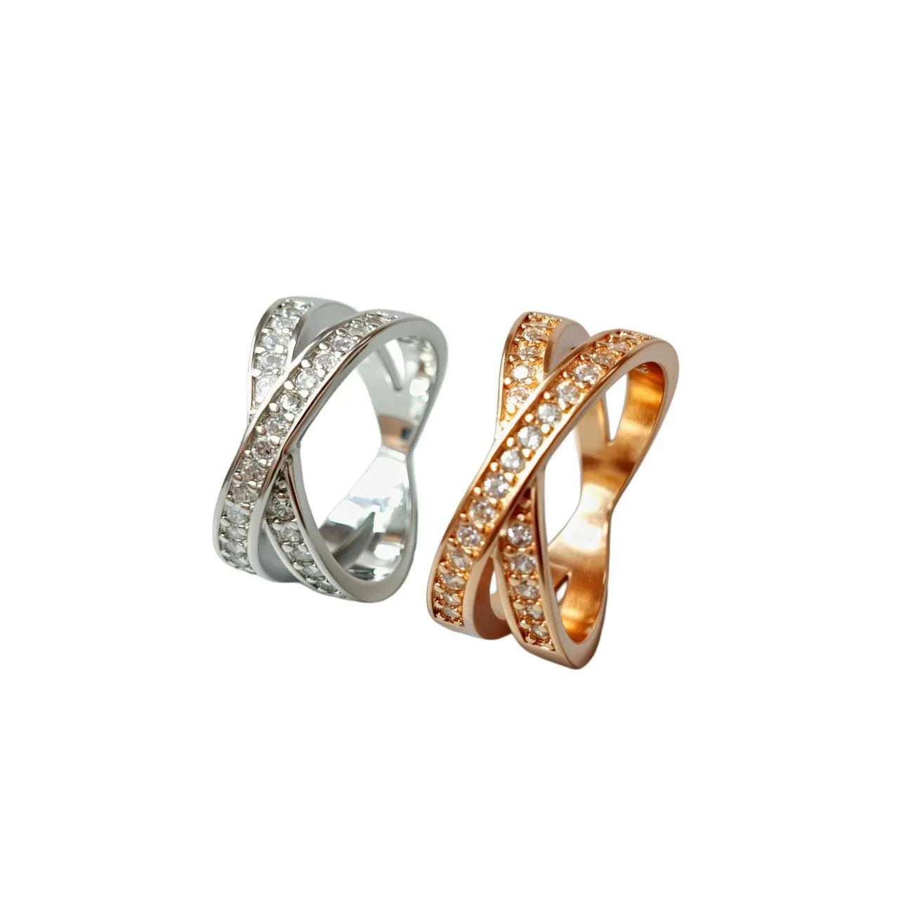 Silver and rose gold metal cross ring with micro-inlaid zircon stones in heart and geometric shapes.