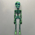 Large white 3D printed skull fridge magnet on a refrigerator door.