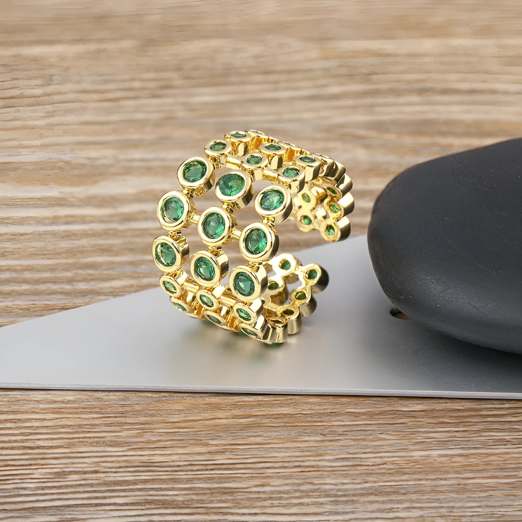 Copper ring with 18K gold plating showing three-layer exaggerated design with zircon stones