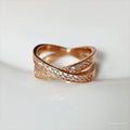 Silver and rose gold metal cross ring with micro-inlaid zircon stones in heart and geometric shapes.