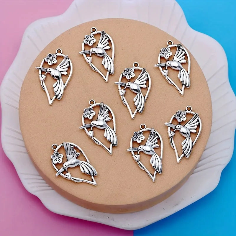 Close-up of an alloy cuckoo magpie pendant with electroplated finish in colour P234 for DIY jewellery.