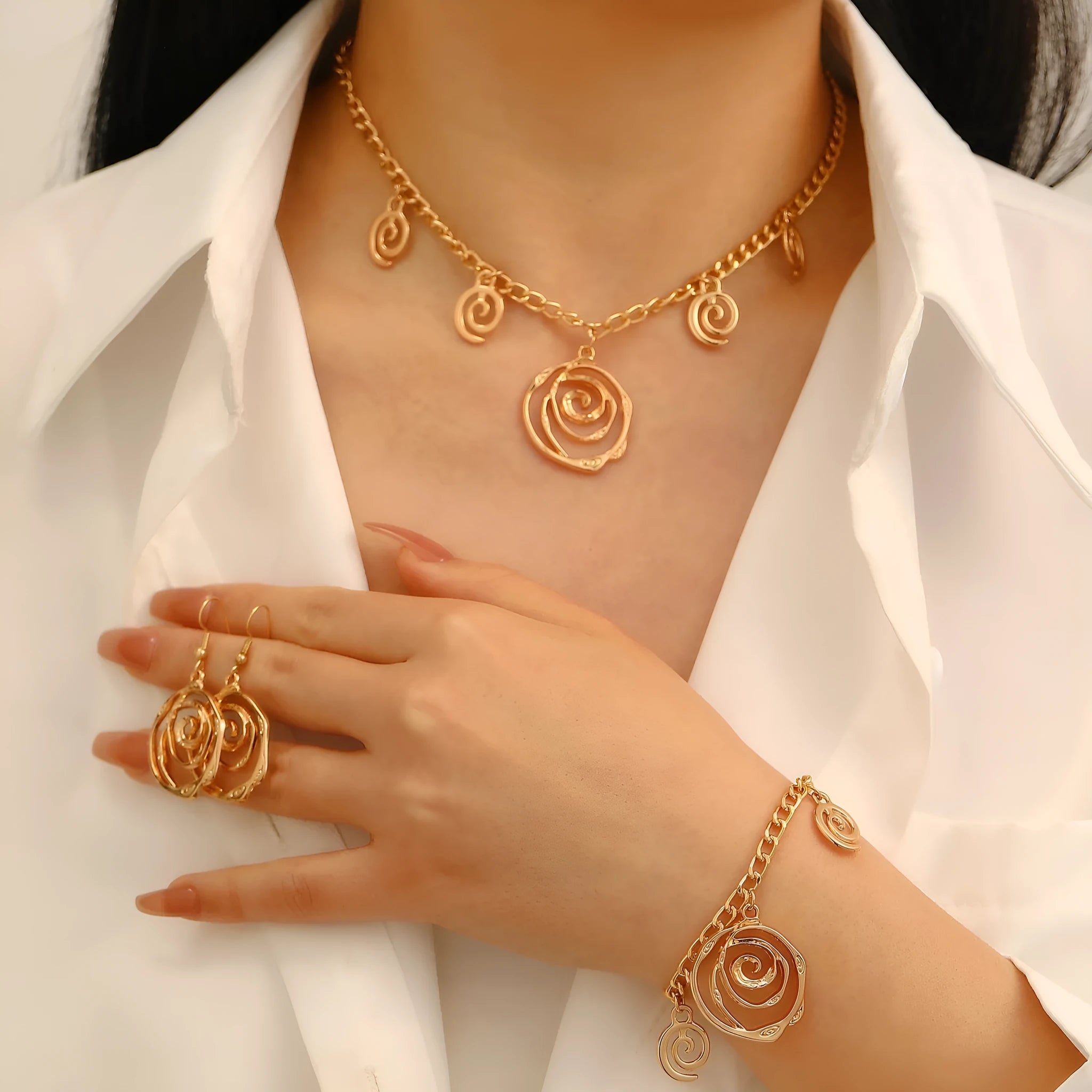 Gold spiral donut jewellery set showing necklace, bracelet and earrings with geometric circle design