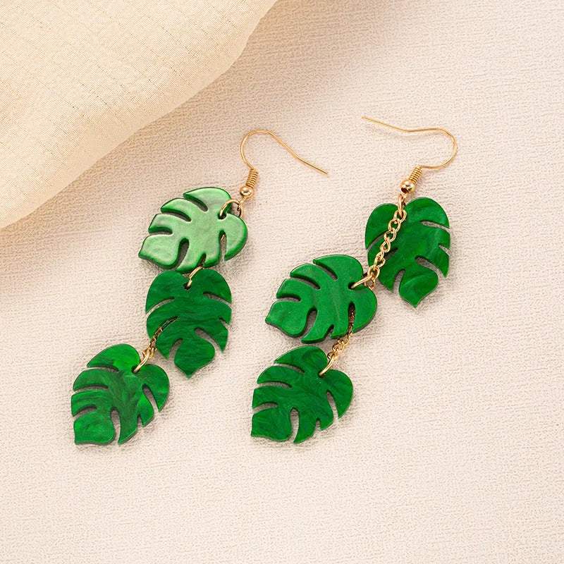 Alloy drop earrings with a blue acrylic artocarpus heterophyllus design and hook fastening.