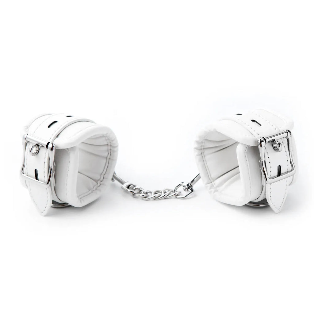 White PU sponge bondage set showing ankle bracelet, handcuffs, footcuffs, and a neck scarf.