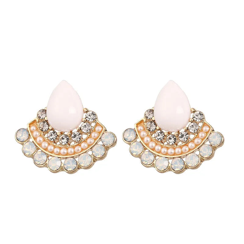 Silver fan-shaped geometric drop earrings with rhinestones on a white background.