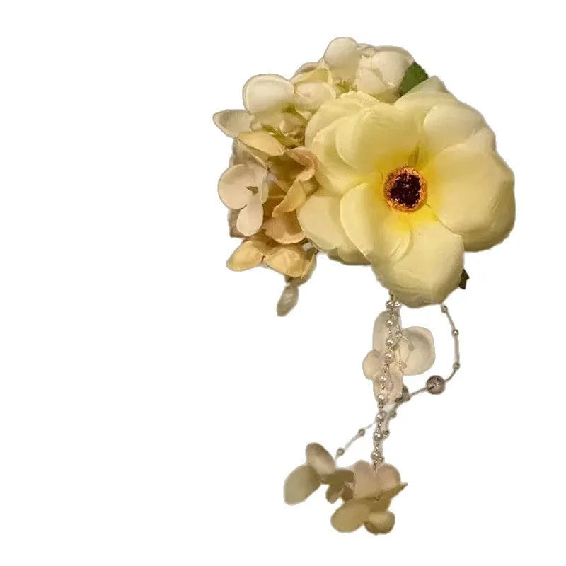 Yellow flower tassel side clip hair accessory with mixed material construction and manual processing details