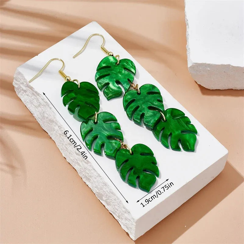 Alloy drop earrings with a blue acrylic artocarpus heterophyllus design and hook fastening.