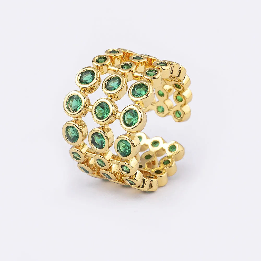 Copper ring with 18K gold plating showing three-layer exaggerated design with zircon stones