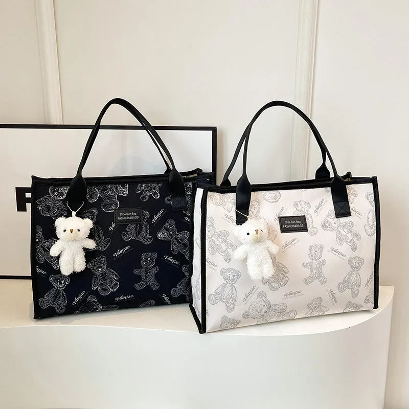 Women's black and white rhombus print canvas tote bag with horizontal square shape and shoulder strap