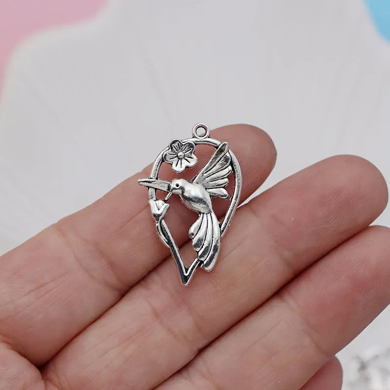 Close-up of an alloy cuckoo magpie pendant with electroplated finish in colour P234 for DIY jewellery.