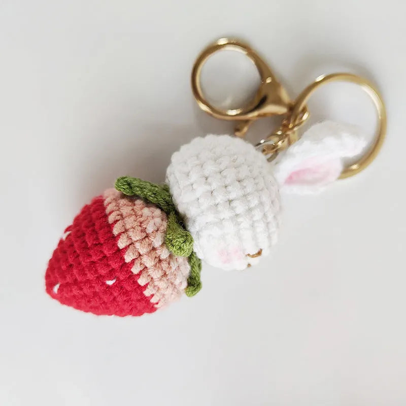 Colourful hand-woven wire rabbit strawberry pendant on a keyring