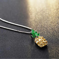 Silver geometric pineapple and diamond pendant necklace on a model.