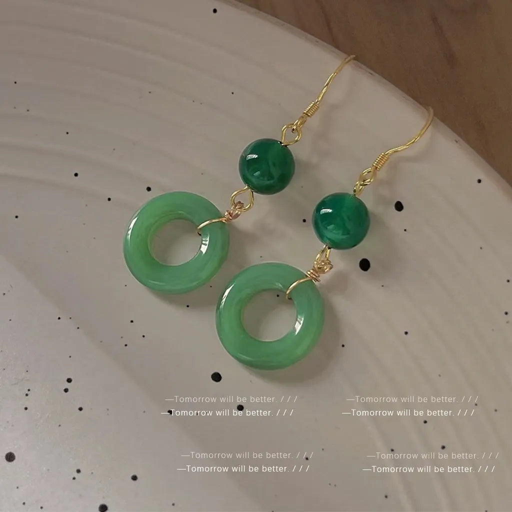 Pair of green Chinese style peace buckle geometric earrings with gold plating.