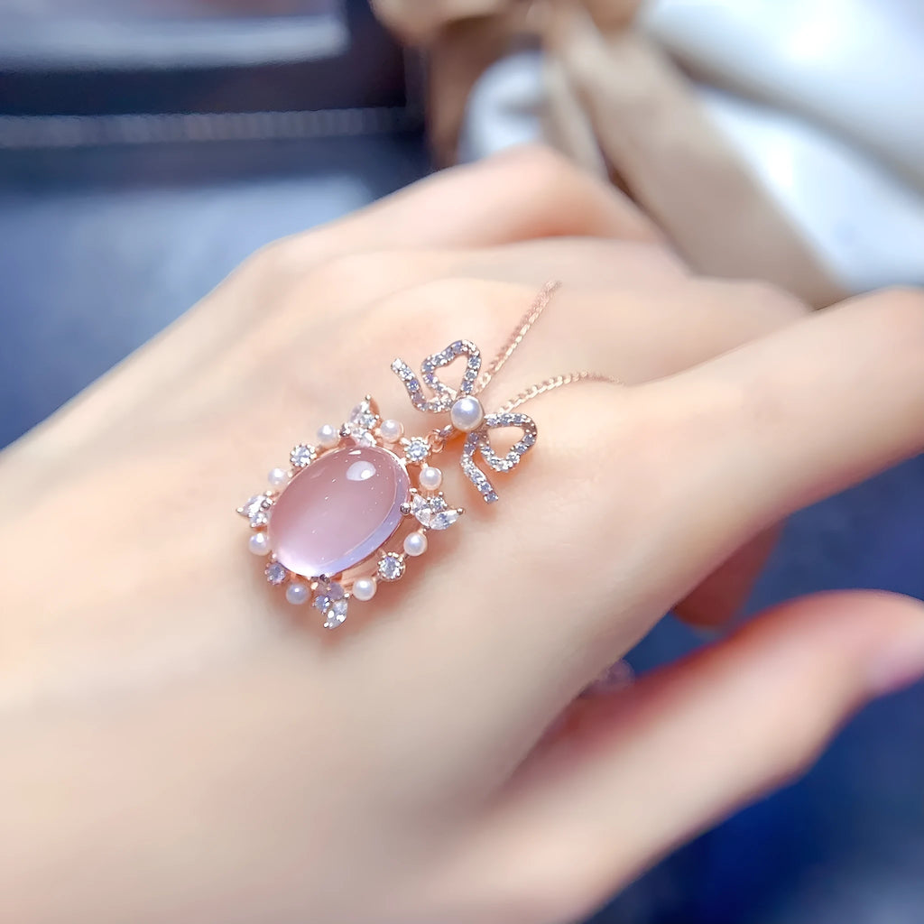Rose gold plated geometric pendant with pink rose quartz stone on a silver chain.