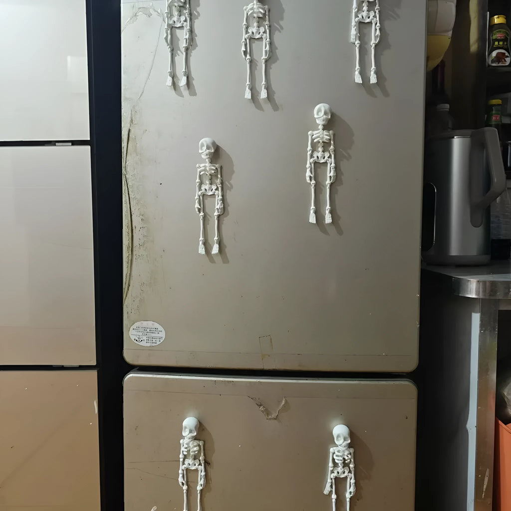 Large white 3D printed skull fridge magnet on a refrigerator door.